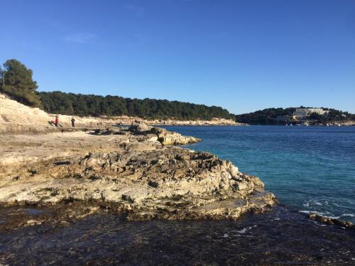 a group of people on a beach near the water at Monte Paradiso Panorama in Pula