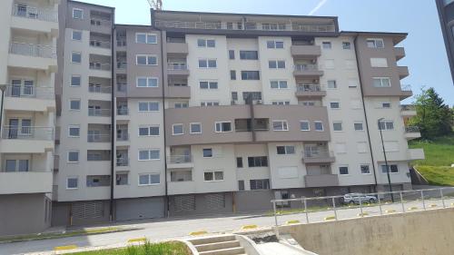 an apartment building with a parking lot in front of it at Turistic Apartments Centar Sarajevo in Sarajevo