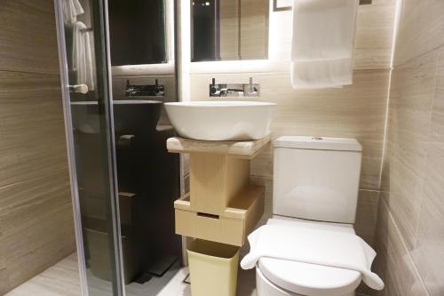 a bathroom with a toilet and a sink at The Harbourview in Hong Kong