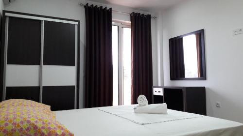 a bedroom with a bed and a large window at Apartments Sija in Ulcinj