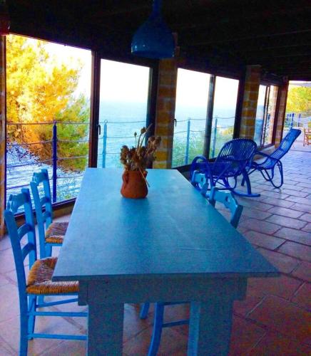 a blue table and chairs on a patio at VILLE GIRASOLI "VILLA NELLA BAIA" with PRIVATE SWIMMING POOL in Tricase