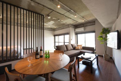 a living room filled with furniture and a large window at A Good Day Fukuoka Riverside in Fukuoka