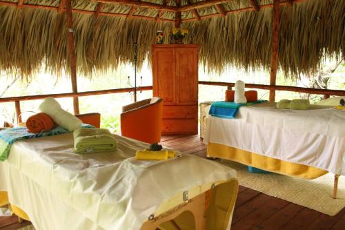 a room with two beds in a thatched tent at Hotel Chipinque in Monterrey