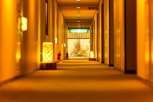 an empty hallway in a building with a window at Hachimantai Mountain Hotel & Spa in Hachimantai