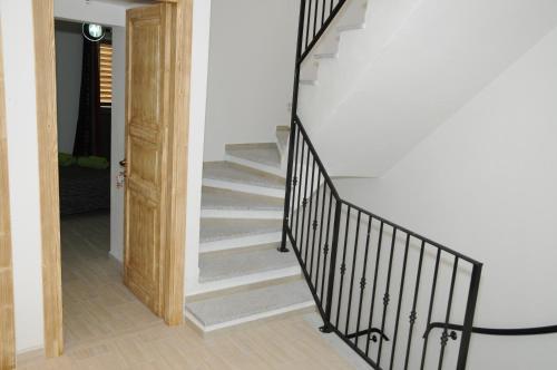 a staircase with black railings in a house at b&b Franzisca in Torpè