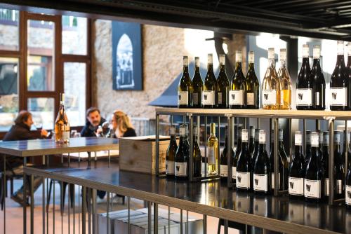 a bunch of bottles of wine on display in a bar at Domaine Calmel & Joseph in Montirat