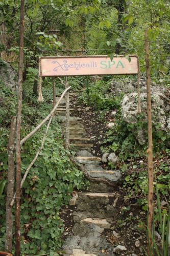 a sign on a trail in a forest with a stone path at Hotel Chipinque in Monterrey