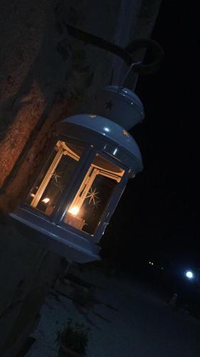 a blue light hanging from a building at night at B&B Terre dì Montecoco in San Pancrazio Salentino