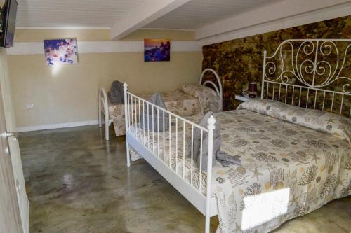 a bedroom with a white bed and a couch at B&B Vistamar in San Nicola Arcella
