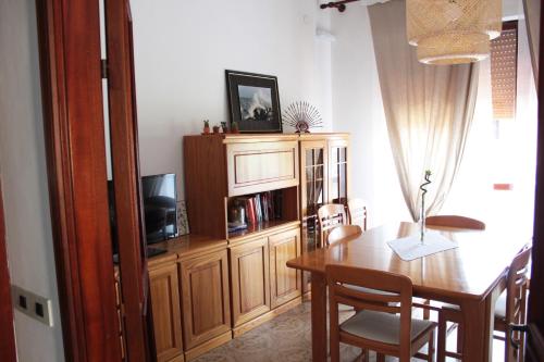 a dining room with a table and a entertainment center at Marilide in Marotta