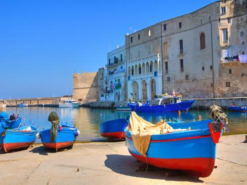 a group of boats parked next to a body of water at Casa San Vito in Monopoli
