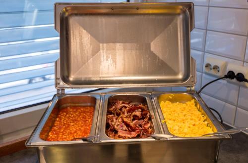 a metal container filled with different types of food at Enter Amalie Hotel in Tromsø