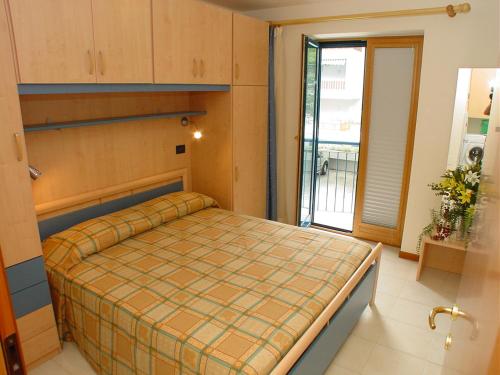 a bedroom with a bed in a room with a window at Residence Terme in Grado