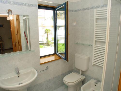 a bathroom with a toilet and a sink and a mirror at Residence Terme in Grado