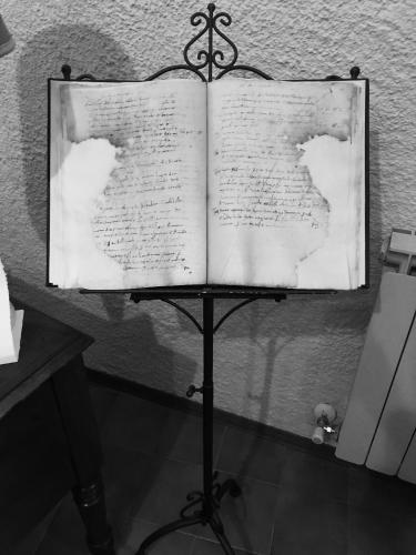 an open book on a stand in a room at B&B La Dimora del Capitano in Fabriano