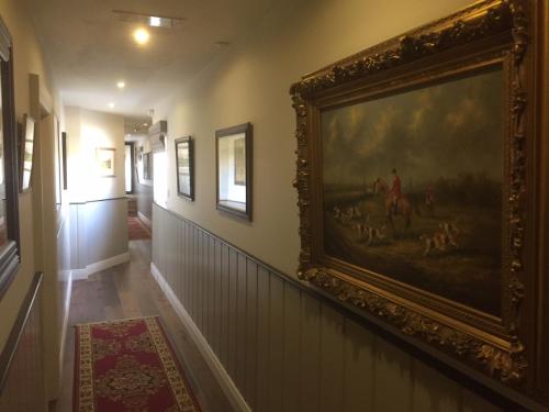 a hallway with a painting on the wall at Horse & Hound in Delgany