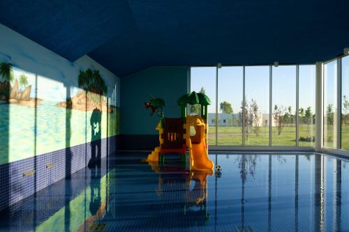 an empty swimming pool with a yellow inflatablequal at Mjus Resort & Thermal Park in Körmend