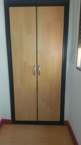 a wooden door in a room with a wooden floor at Hostal Lima in Valladolid