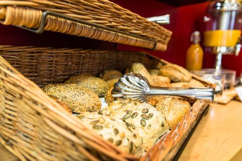 a basket filled with lots of different types of bread at Gästehaus Centro in Konstanz in Konstanz
