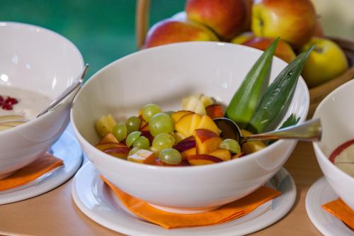 a bowl of grapes and other fruit on a table at Hotel Mohren in Hagnau