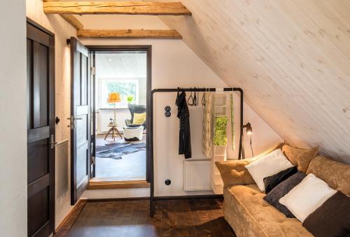 a living room with a couch in a attic at Studio på loftet i Sankt Olof in Sankt Olof