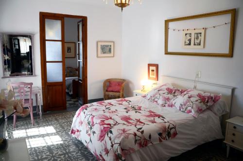 モンテフリオにあるCasa Montefrioのベッドルーム1室(花柄のベッドカバー付)