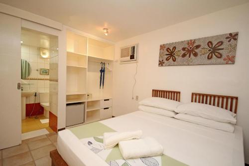 a bedroom with a white bed and a table at Bluewaves Beach House in Boracay