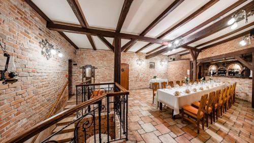 a dining room with a table in a brick building at Hotel Młyn Aqua Spa Biblioteka in Elblag