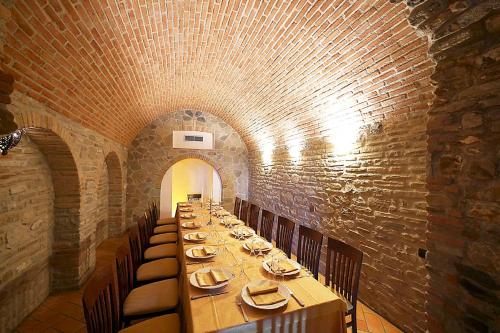 a long dining room with a long table and chairs at Palazzo dei Poeti in Tursi