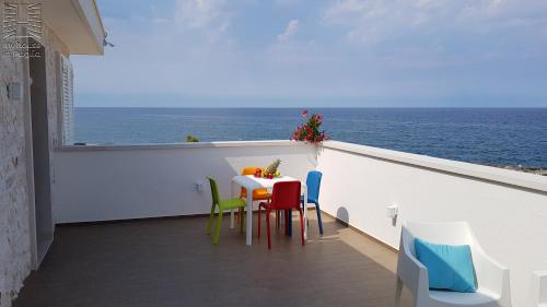 a balcony with a table and chairs and the ocean at Case Vacanza Marzano in Monopoli