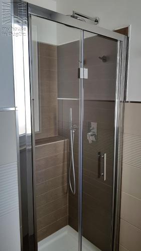 a shower with a glass door in a bathroom at Case Vacanza Marzano in Monopoli