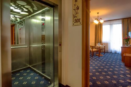 a corridor of a hotel room with a glass door at Hotel Liptakówka in Białka Tatrzanska