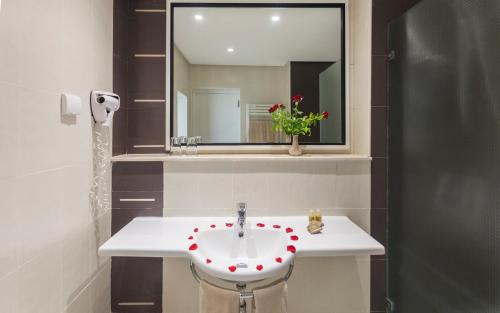 a bathroom with a sink with a flower on it at Seabel Alhambra Beach Golf & Spa in Port El Kantaoui