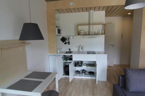 a kitchen with a white counter and a table at Raua 15 Apartment in Tartu