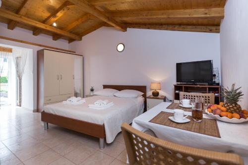 a living room with two beds and a table with fruit at Beach apartment M & B in Poljana