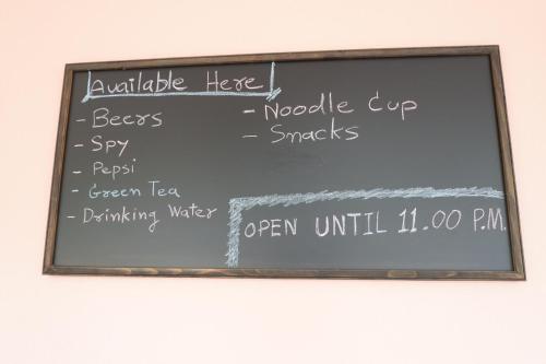 a chalkboard with a menu on a wall at No.17 @ Khaoyai in Mu Si