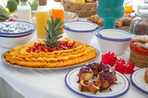 a table with a plate of food on a table at Hotel Piccolo Mondo in Castro di Lecce
