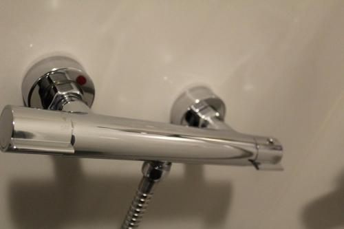a close up of a chrome shower handle at 3-Studio in Poznań