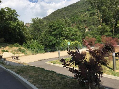 a park with a dog on the side of a road at Le Prieuré in Saint-Dalmas-de-Tende