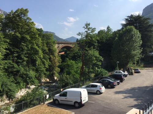 a bunch of cars parked in a parking lot with a bridge at Le Prieuré in Saint-Dalmas-de-Tende
