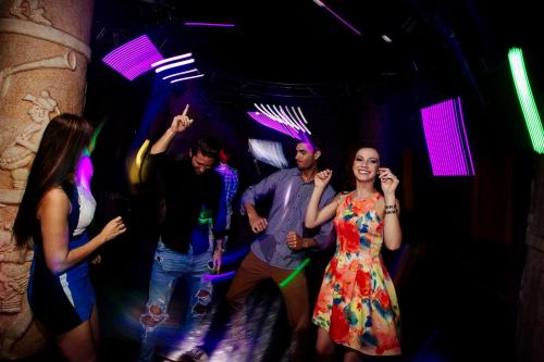 a group of people dancing in a club at Occidental at Xcaret Destination - All Inclusive in Playa del Carmen