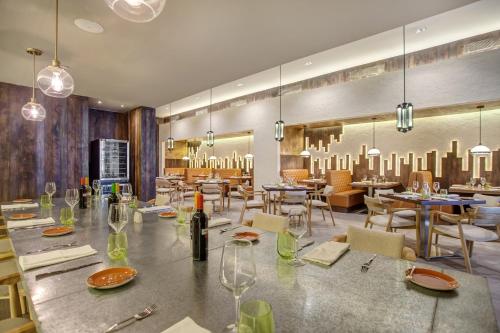a dining room with a table with wine glasses at Grand Lido Negril Au-Naturel, An Autograph Collection All-Inclusive Resort - Adults Only in Negril