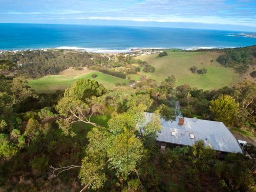 an aerial view of a house on a hill next to the ocean at Beacon Point Ocean View Villas in Apollo Bay