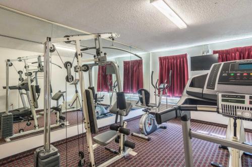 a gym with several tread machines and a treadmill at Days Inn by Wyndham Hartsfield Jackson Atlanta Airport West in Atlanta