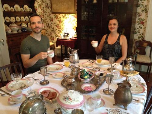 a man and a woman sitting at a table with drinks at Stone House Musical B&B in Natchez