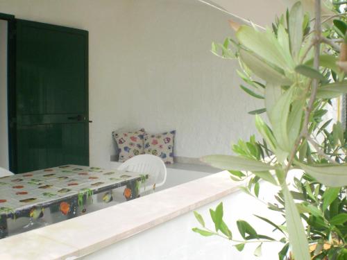 a bedroom with a bed and a chair and a plant at La Marina Bay in Vieste