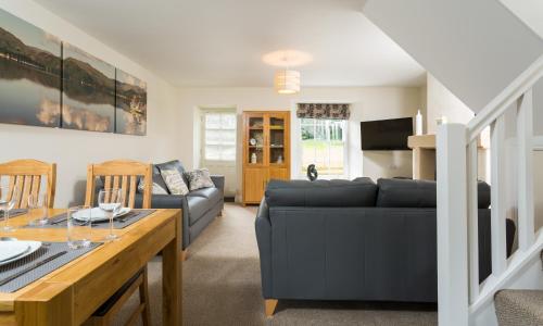 a living room with a couch and a table at Waterfoot Park in Pooley Bridge