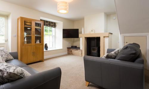 a living room with a couch and a television at Waterfoot Park in Pooley Bridge