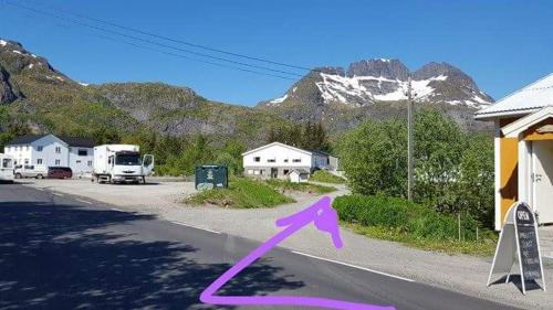 a road with a purple arrow on the side of the road at Sørvågen INN in Sørvågen