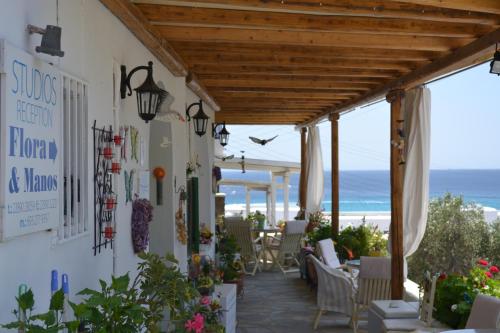 a patio with a view of the ocean at Studios Flora Manos in Platis Gialos